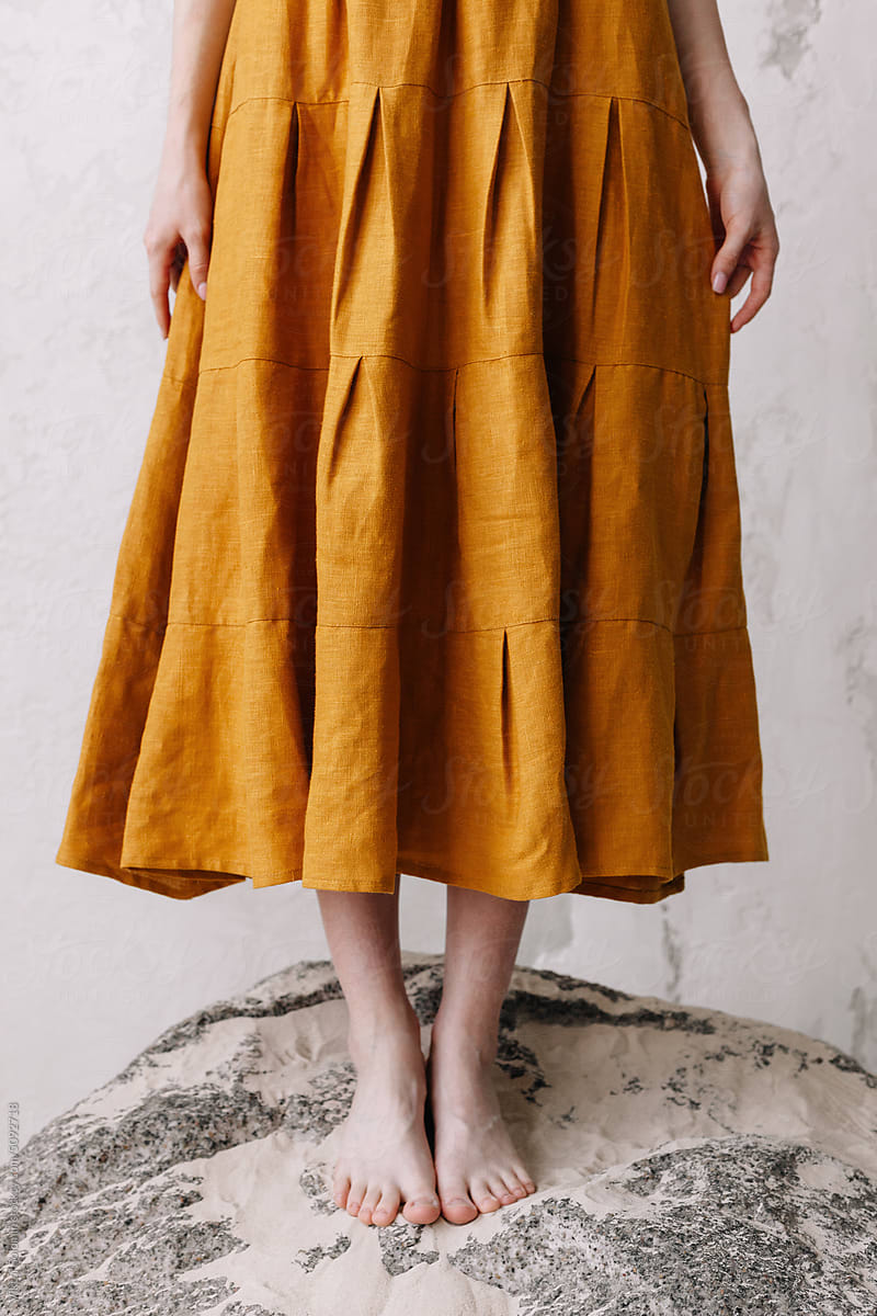 Crop woman in mustard color retro dress in studio