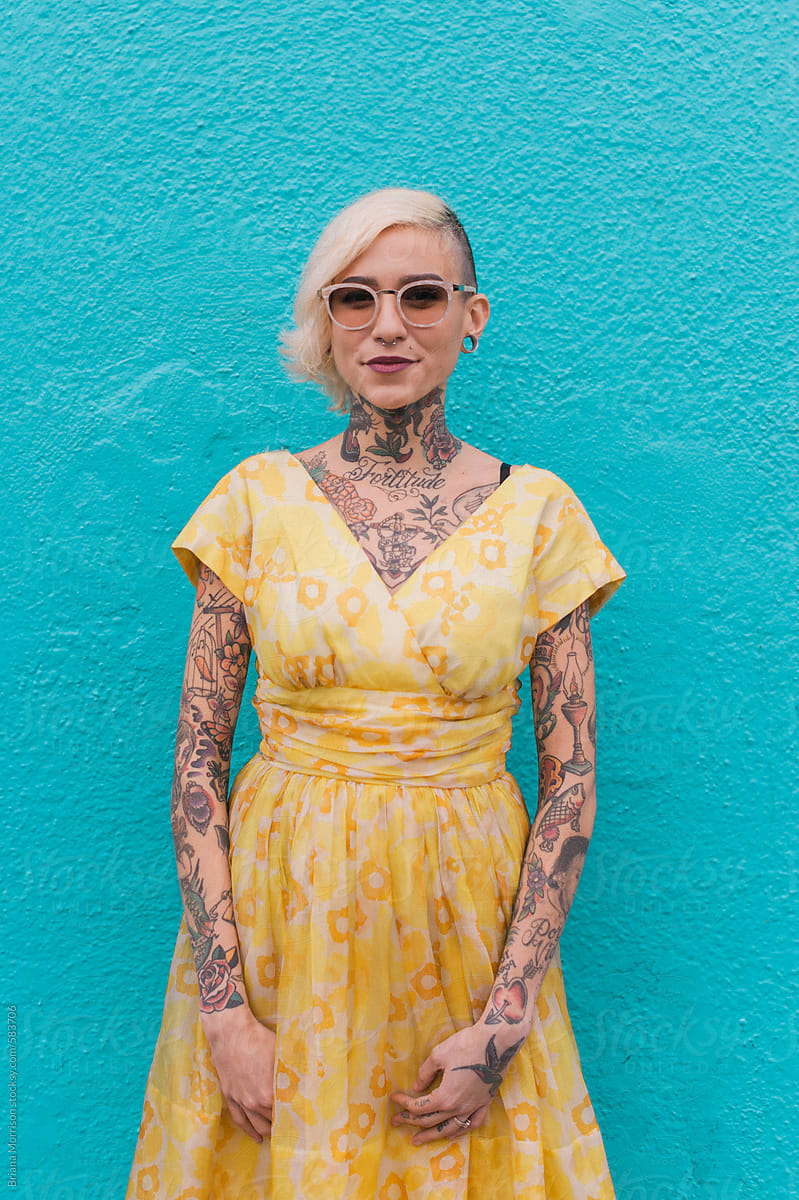 Portrait of a Young Tattooed Woman Wearing Sun Glasses