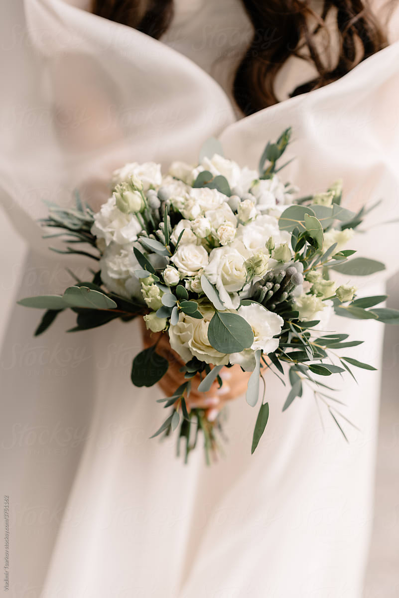 bride with wedding flower bouquet in hands