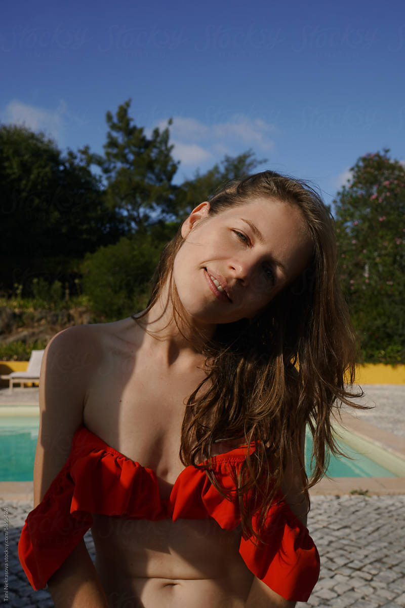 Summer portrait of a smiling girl in orange swimsuit. Portugal