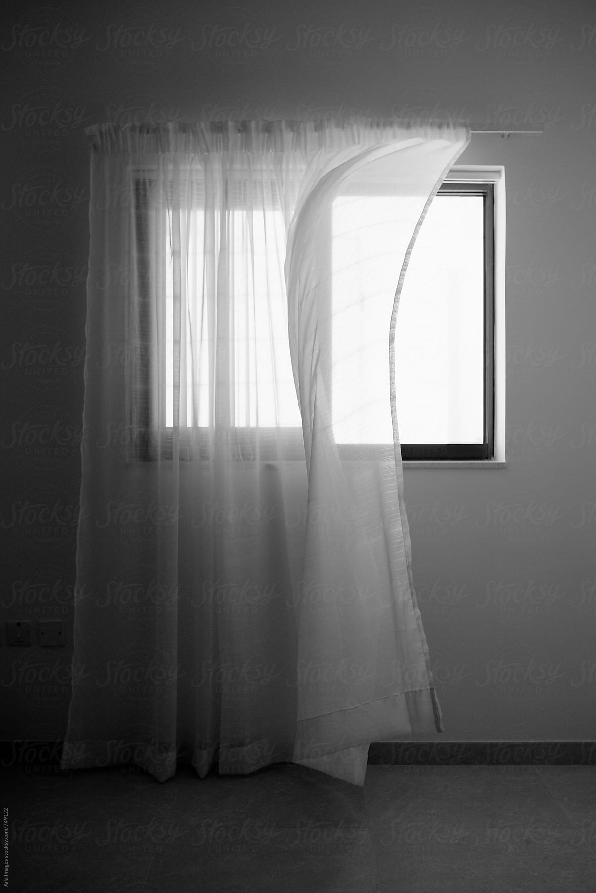 Curtain blowing in black and white