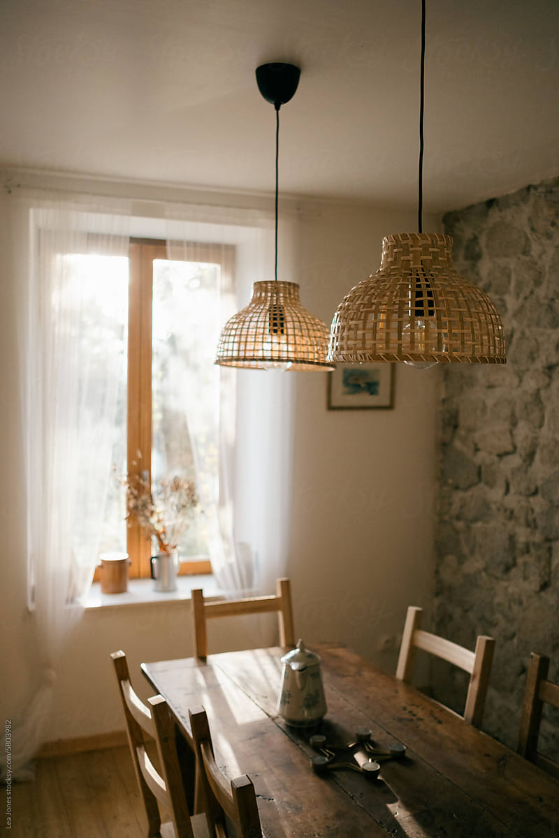table and French windows with morning light and dried bouquet