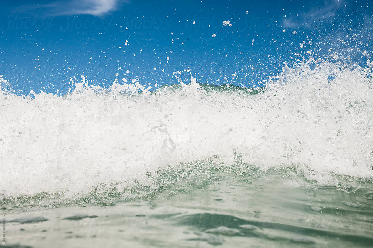 Powerful sea wave foam with blue sky