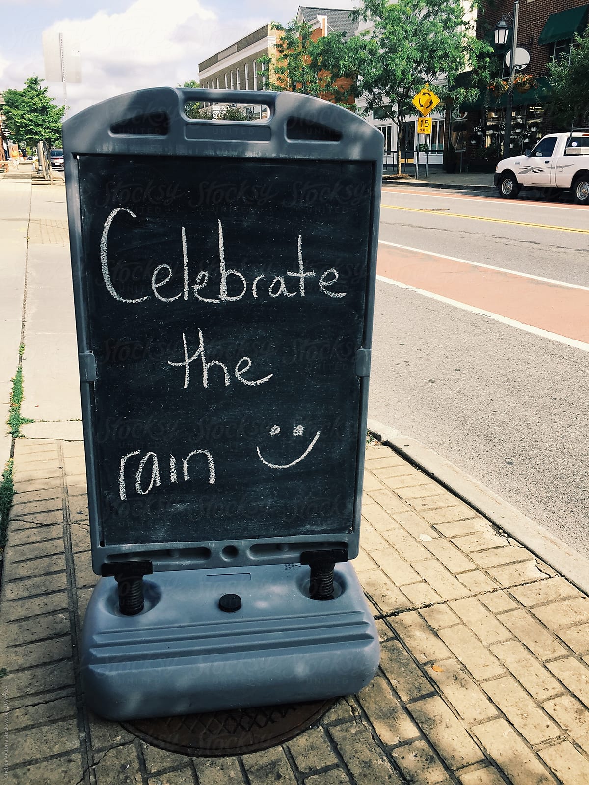 A sign that says celebrate the rain