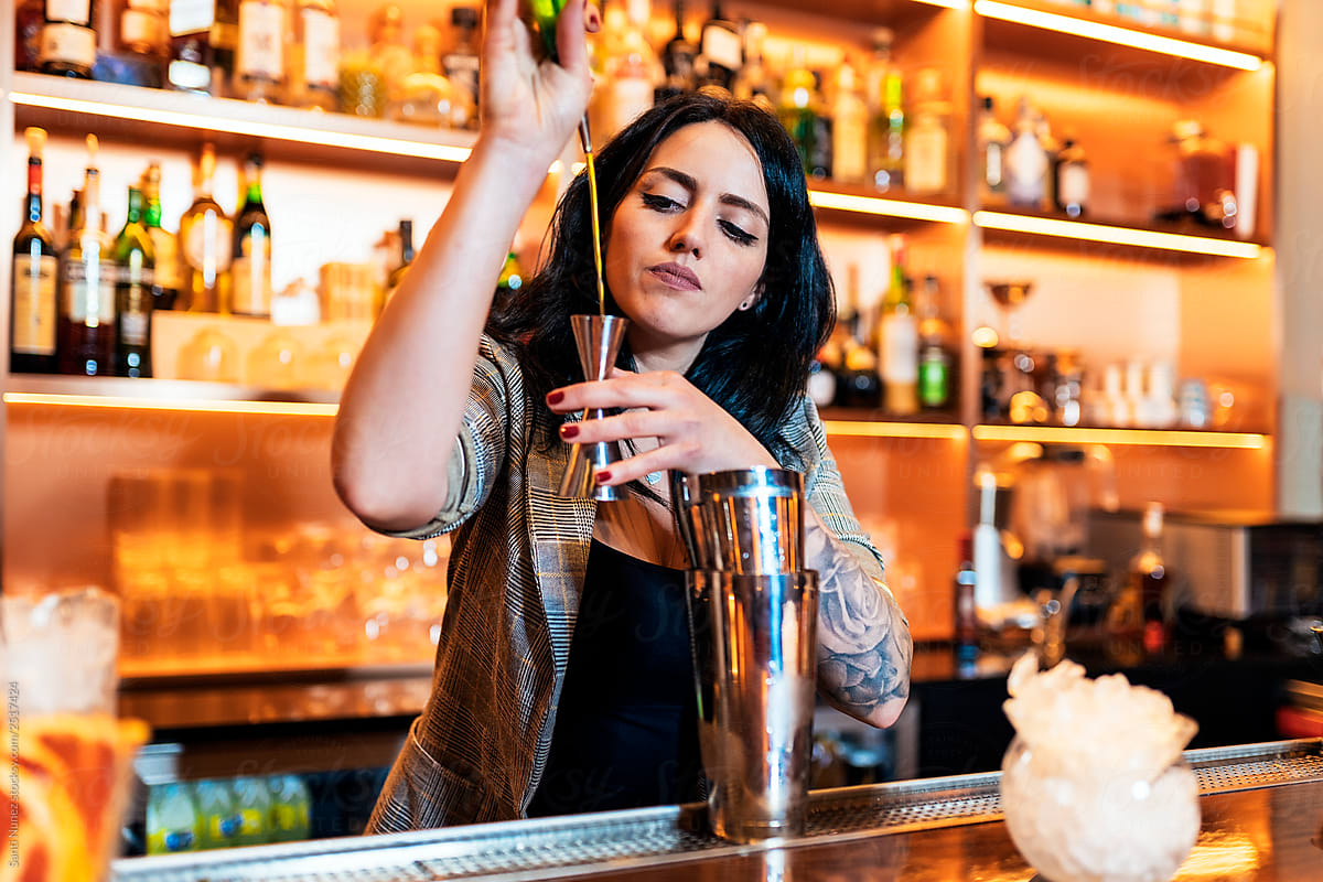 Professional young woman bartender working