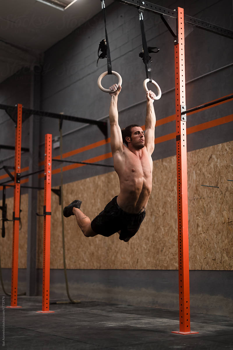 Acrobatic crossfit rings workout at the gym