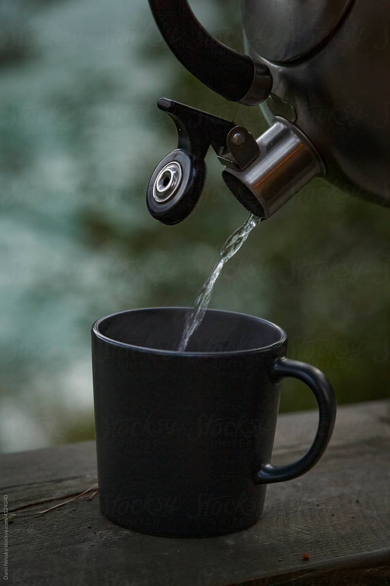 Camping teapot and cup in nature
