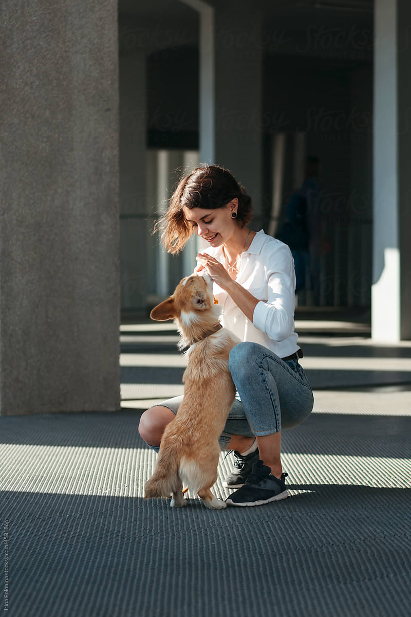 Woman with dog outdoor.