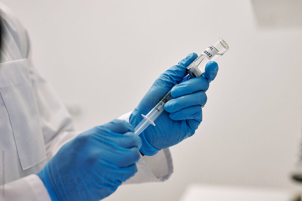 Medical staff preparing vaccine to administering