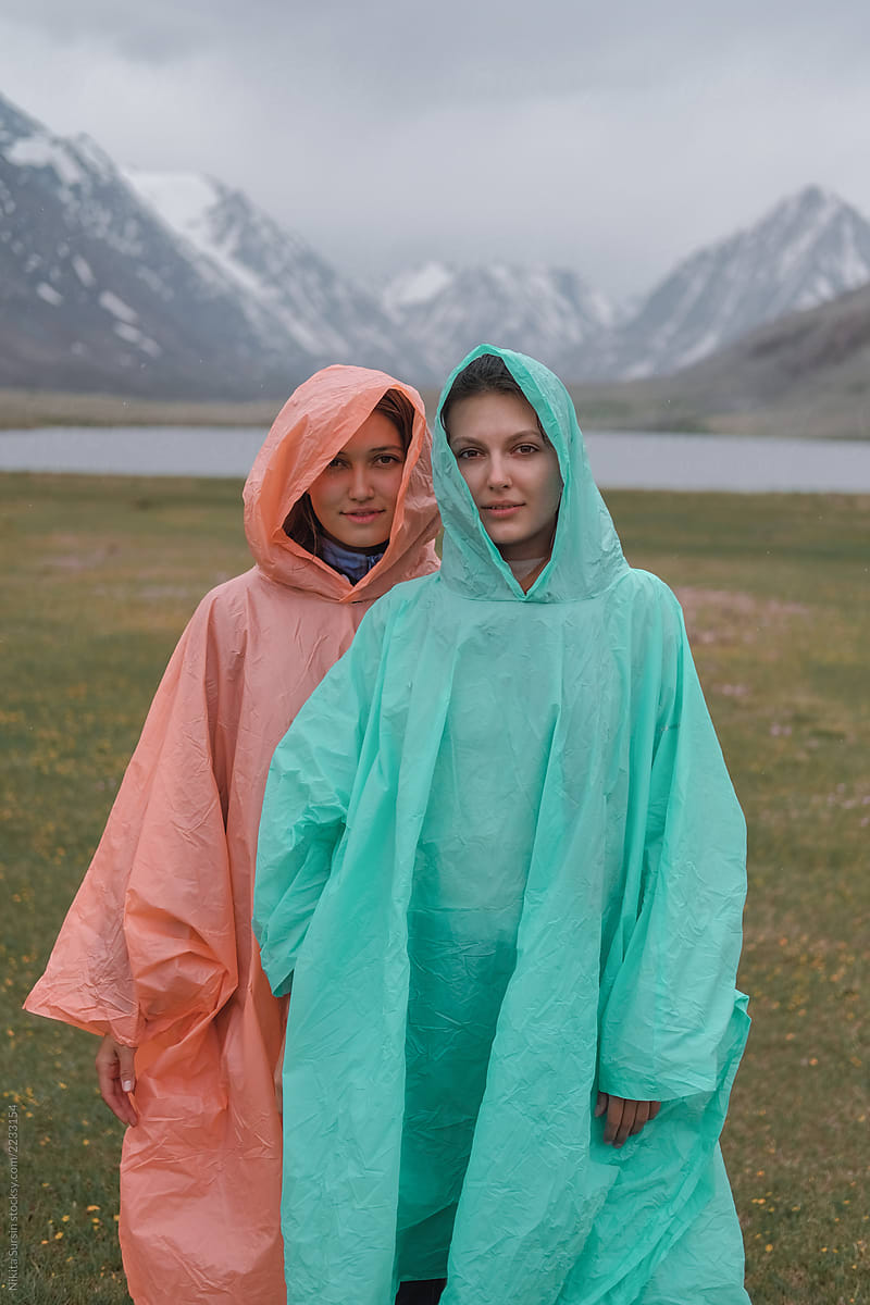 two sisters posing in raincoats