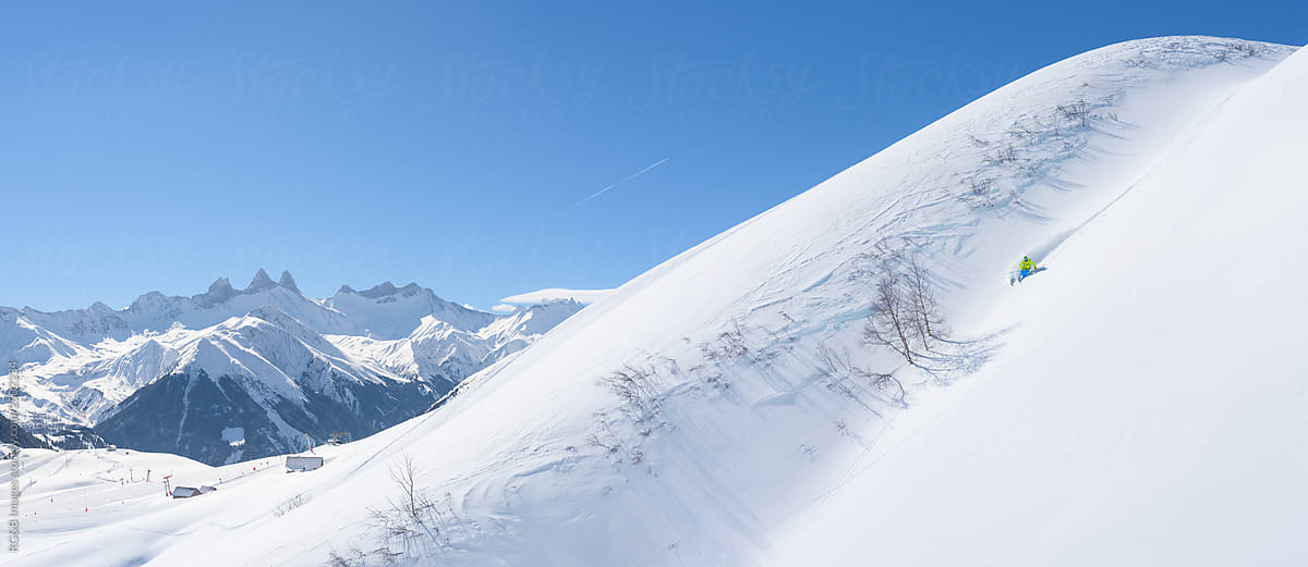 Winter mountain panorama with skier skiing