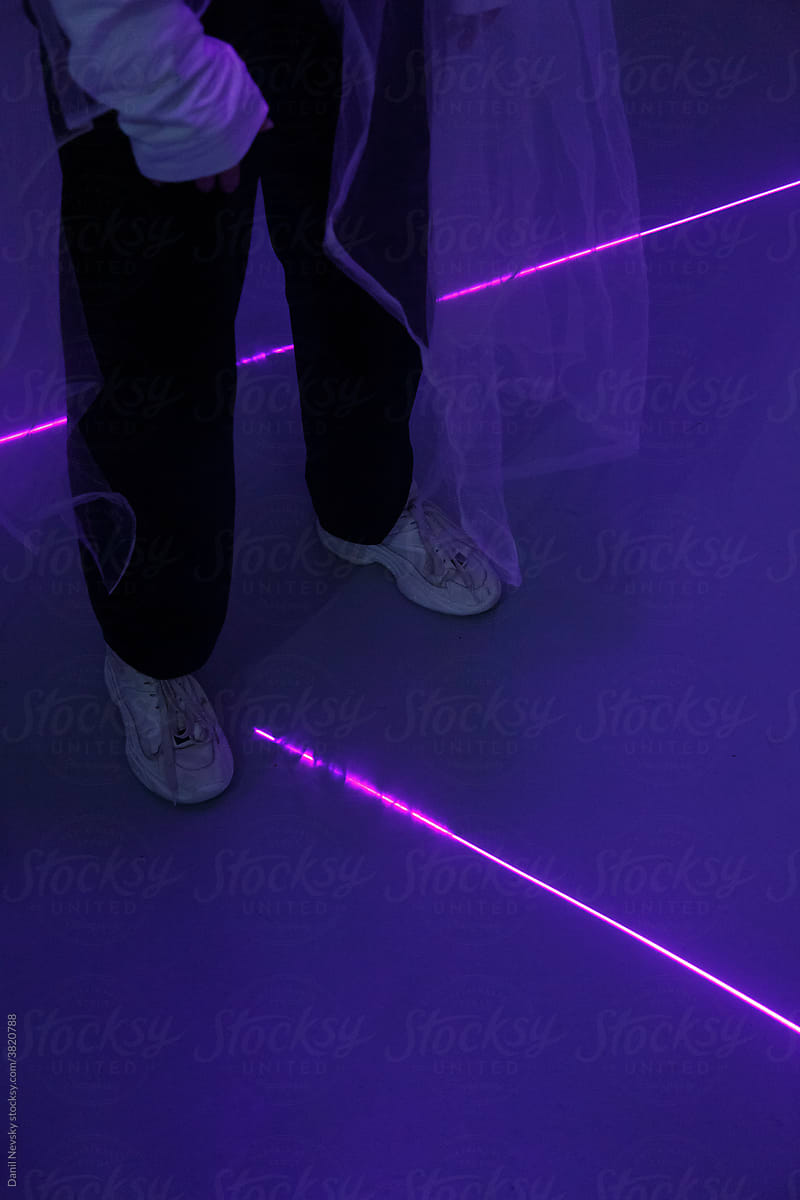 Anonymous person on dance floor with neon lights