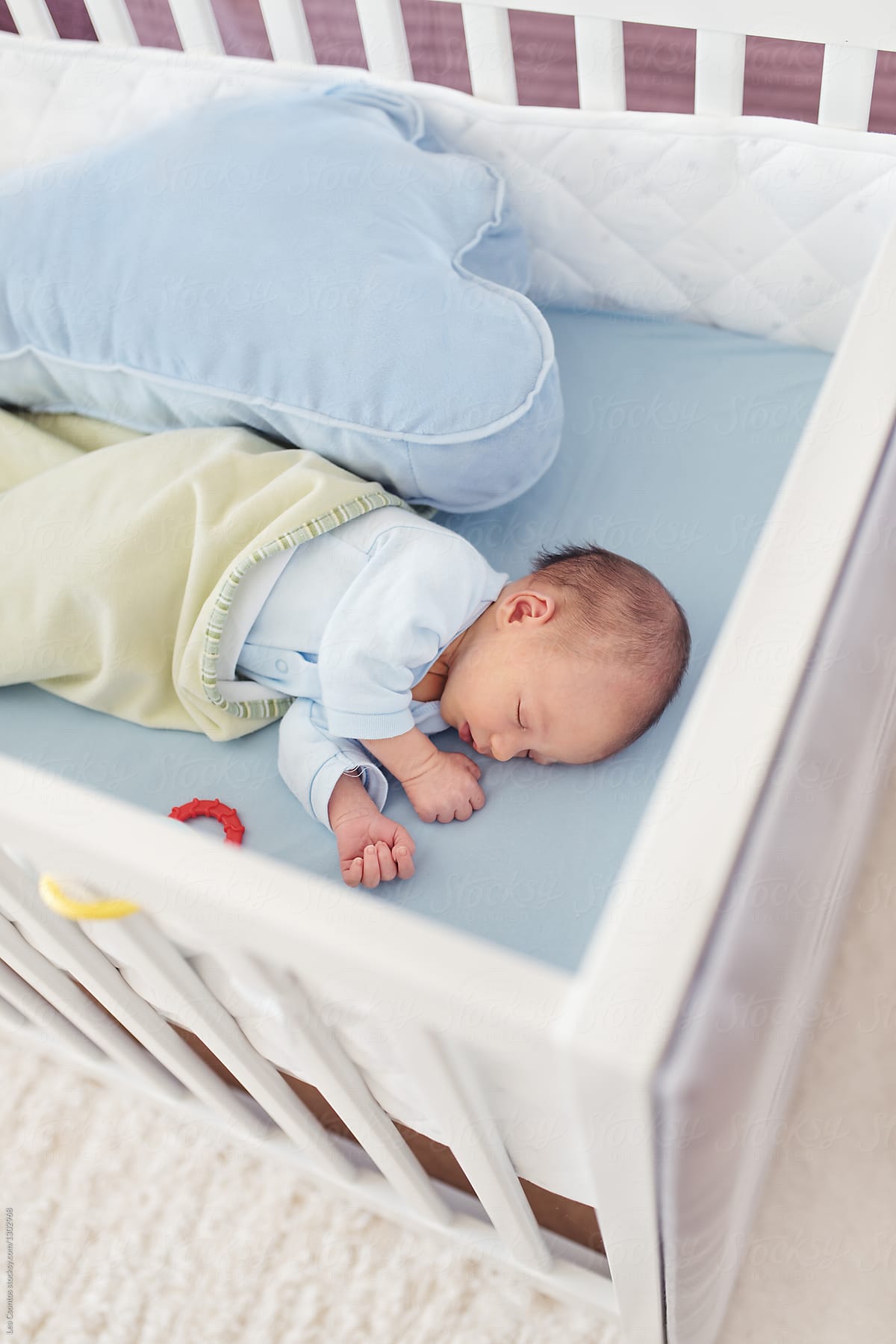 Newborn baby sleeping in a white crib