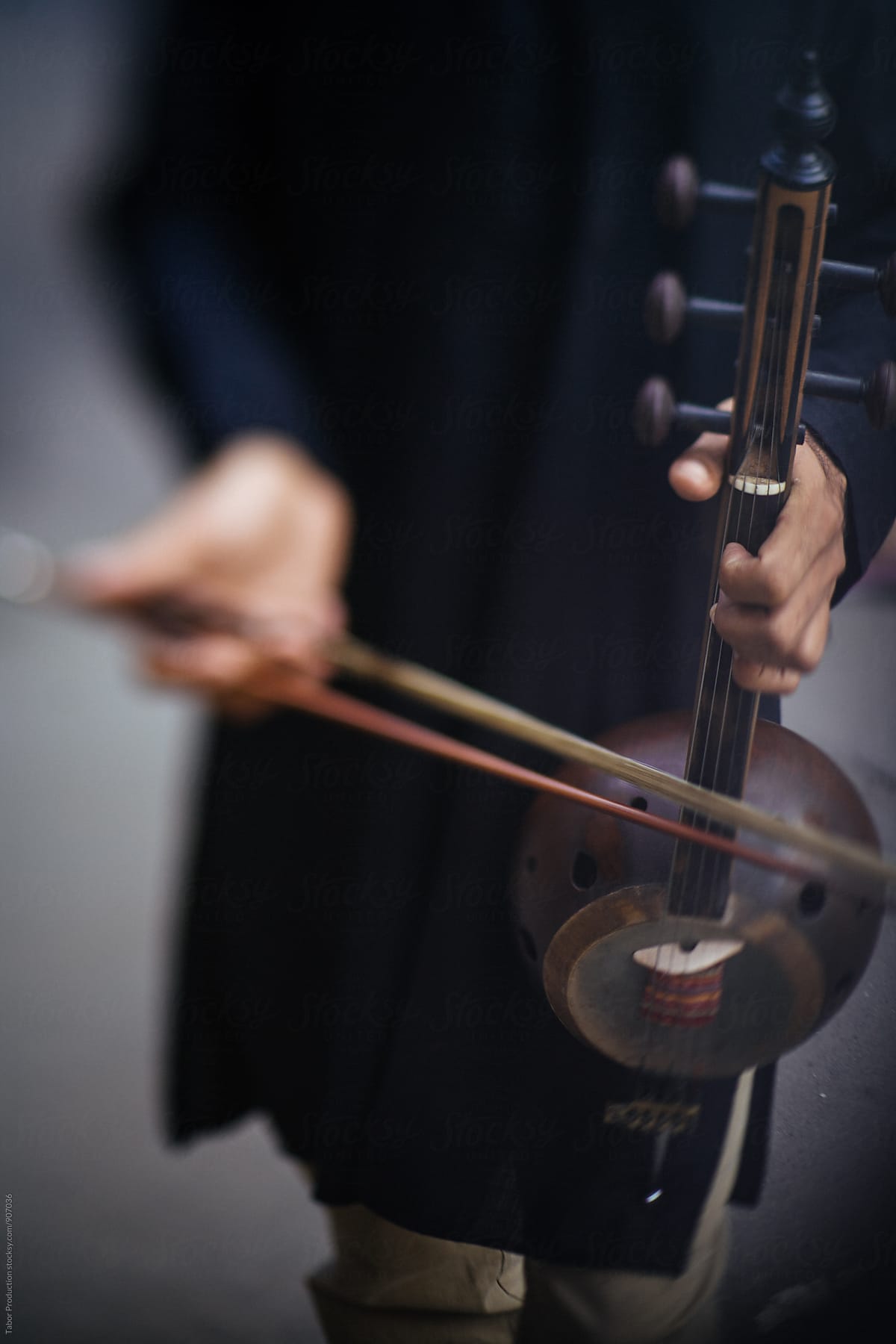 Musician holding kamancha