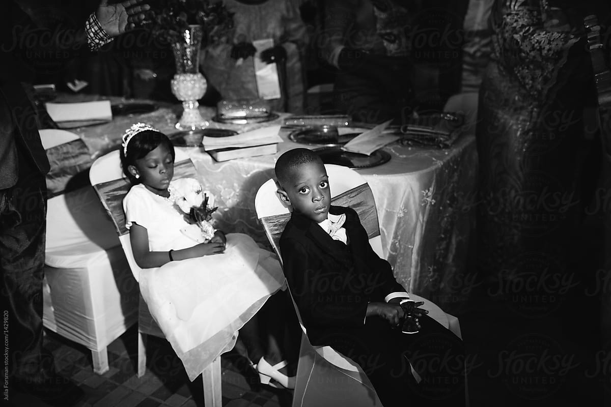 Two very tired children at a Nigerian wedding ceremony.