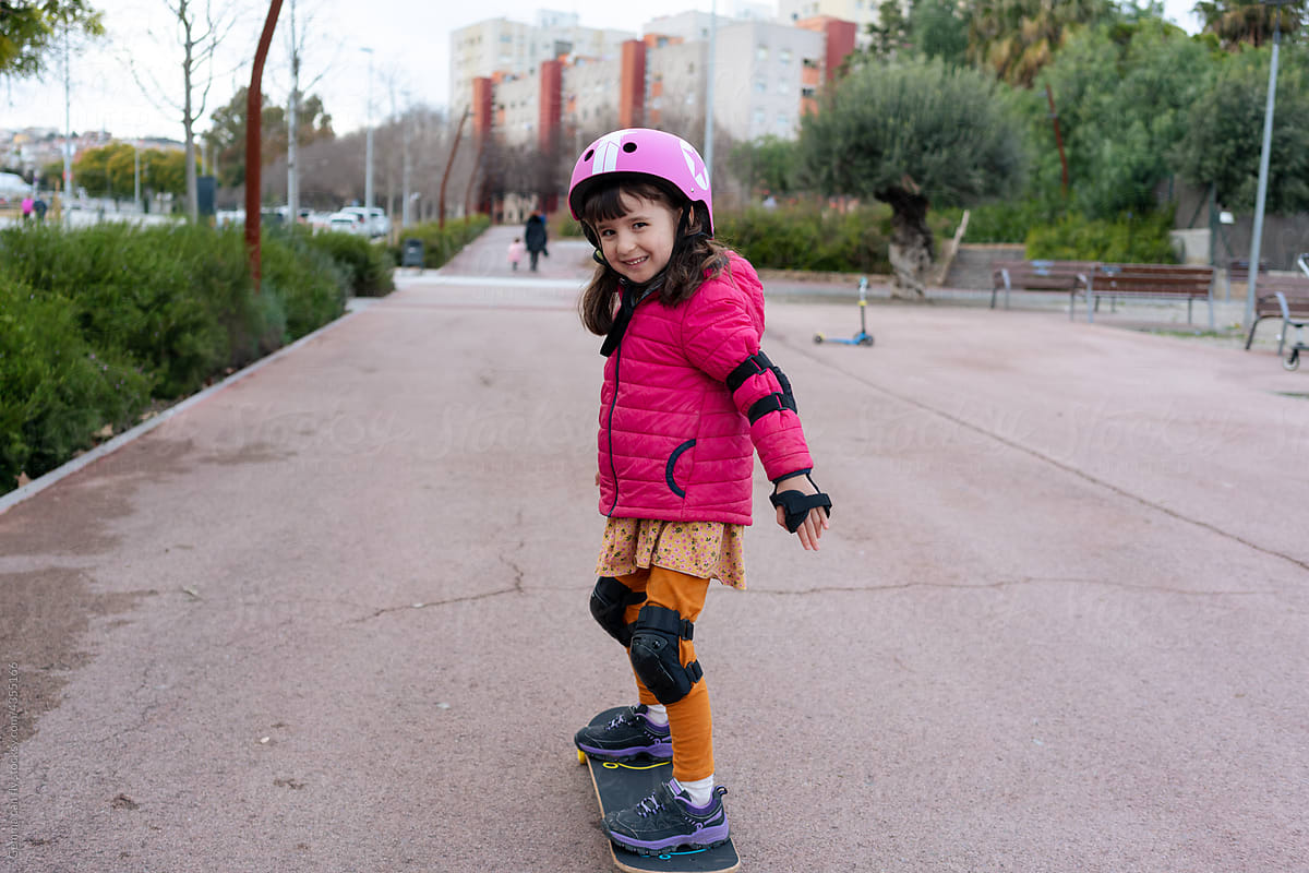Happy little girl on a skate outdoors