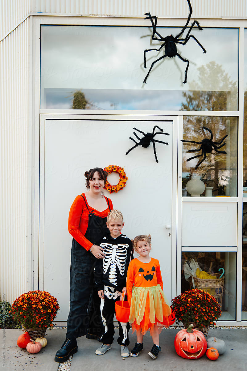 Mother and kids ready for trick or treat outdoors