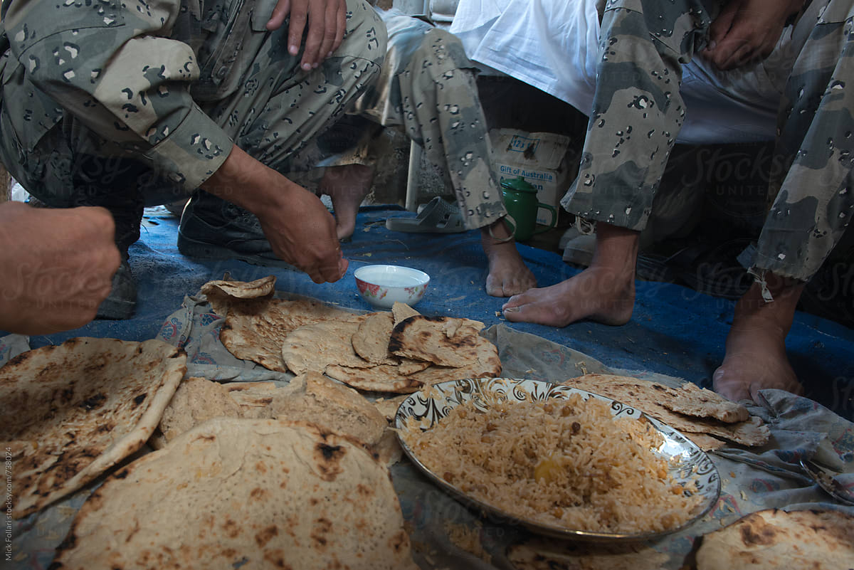 Afghan border police eating naan bread