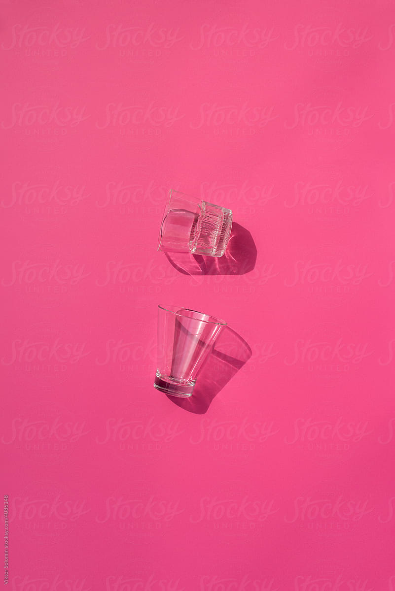 Shot and shooter glasses on pink table