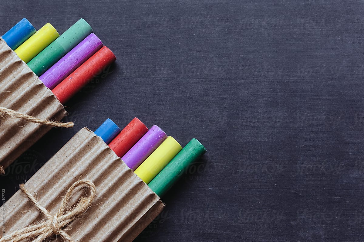 Packaged crayons on a chalk board