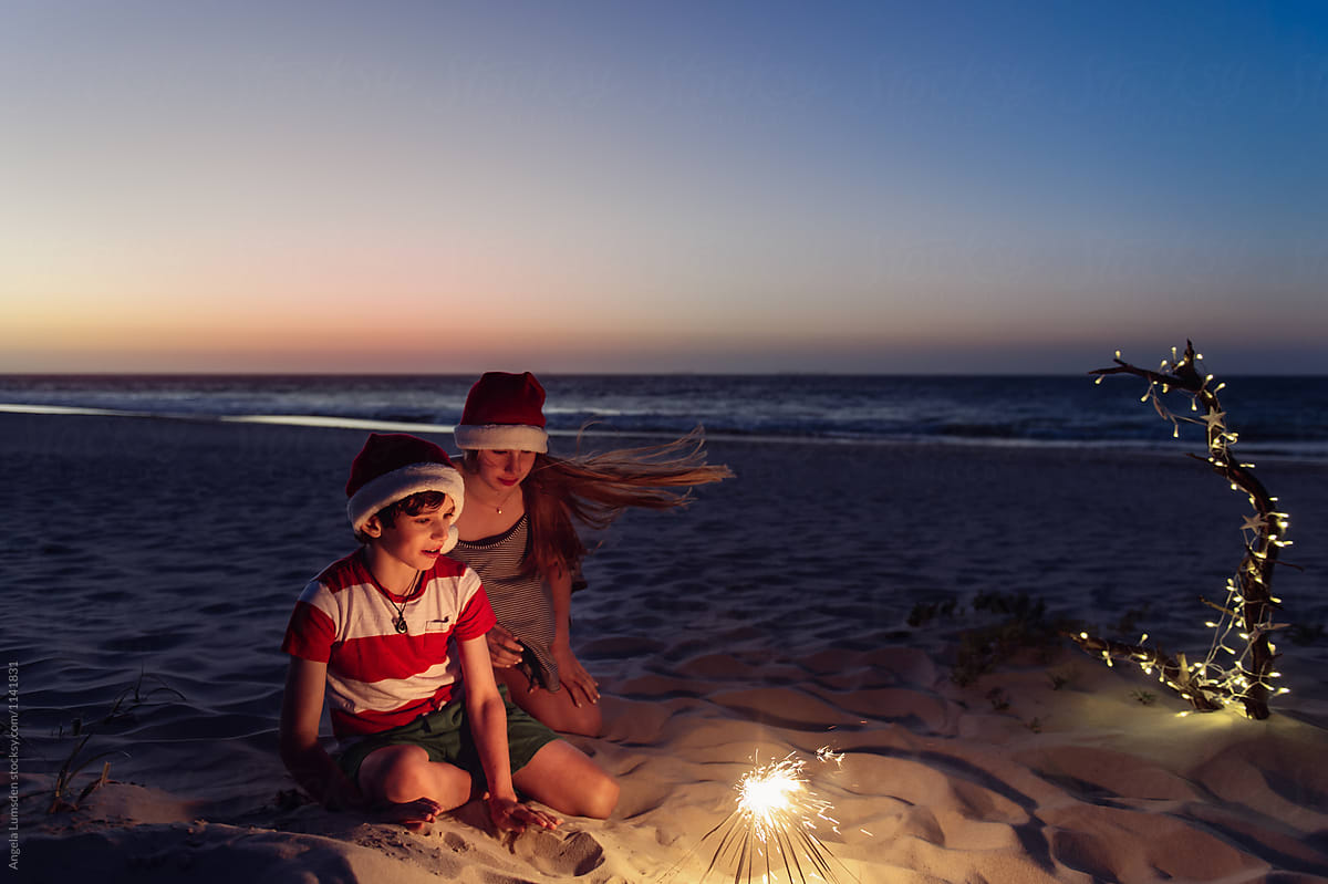 Children with sparklers at the beach at Christmas