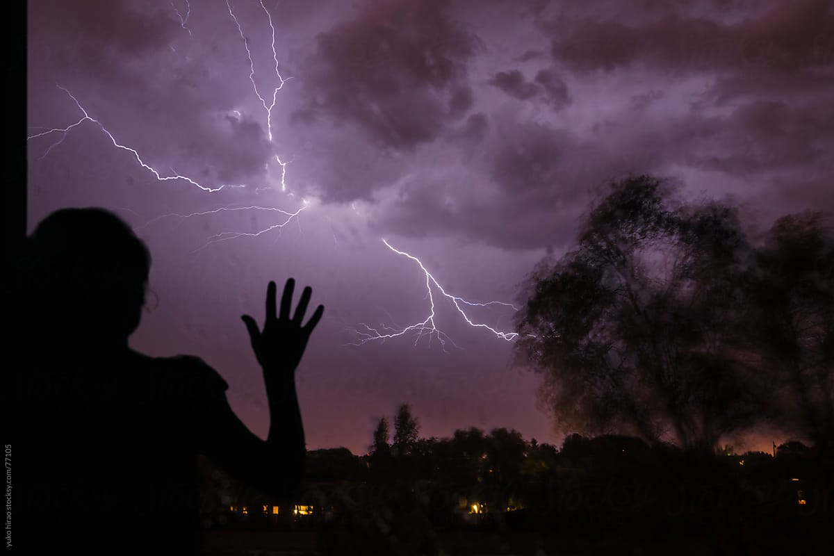 Anxious woman on a stormy night with lightning