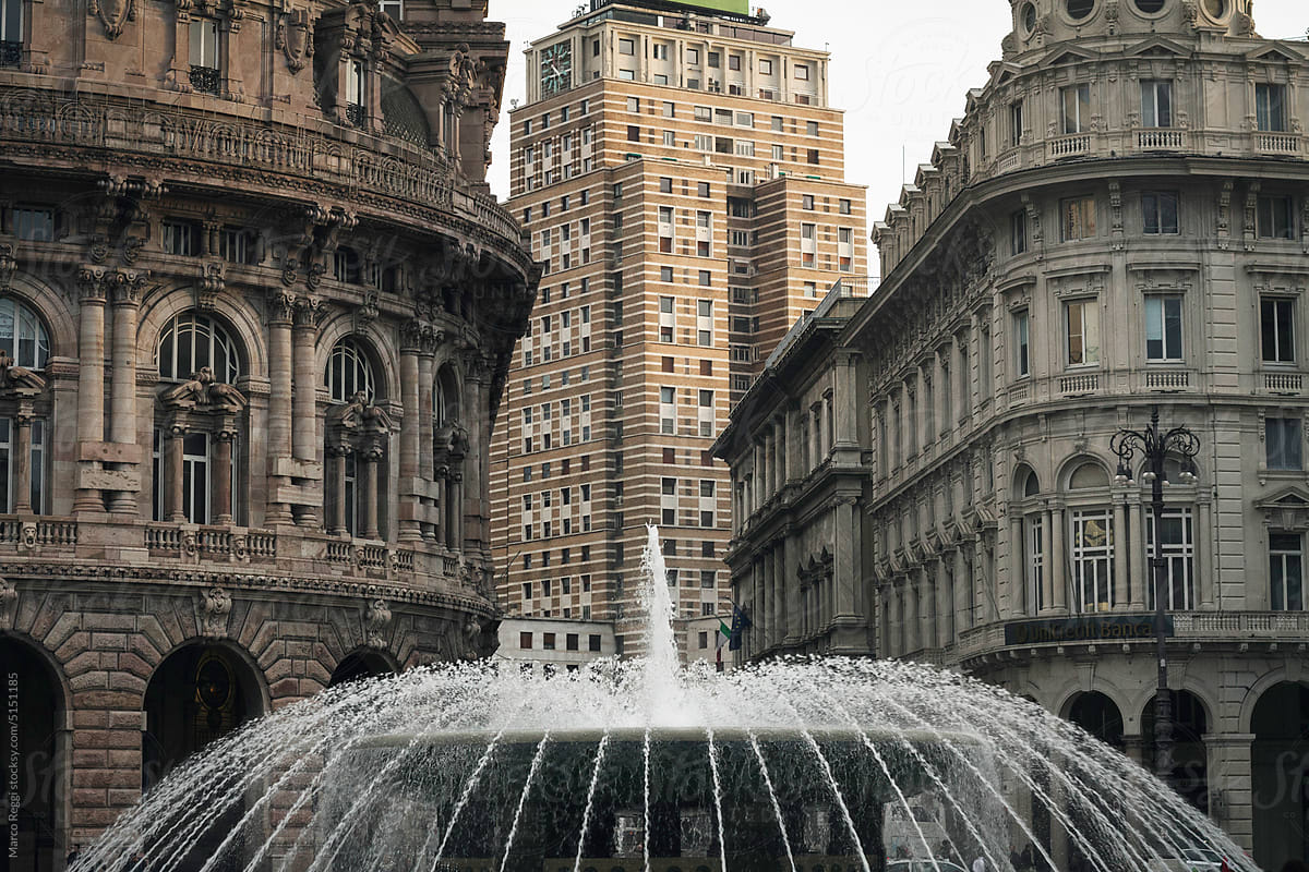 fountain in the city with old buildings