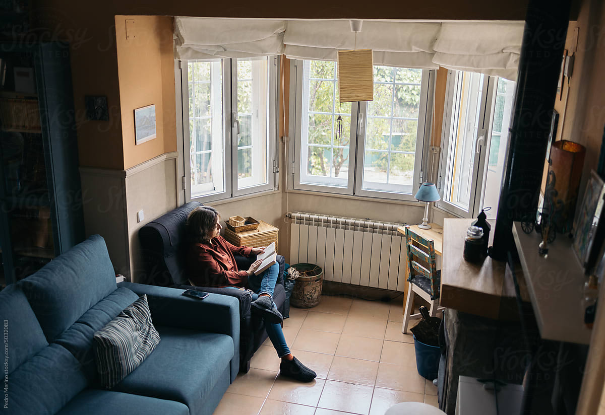 Woman reading in a cozy room at home