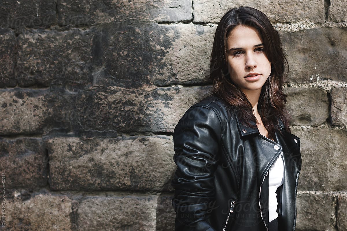 Portrait Of Young Modern Woman Wearing Leather Jacket In Front Old