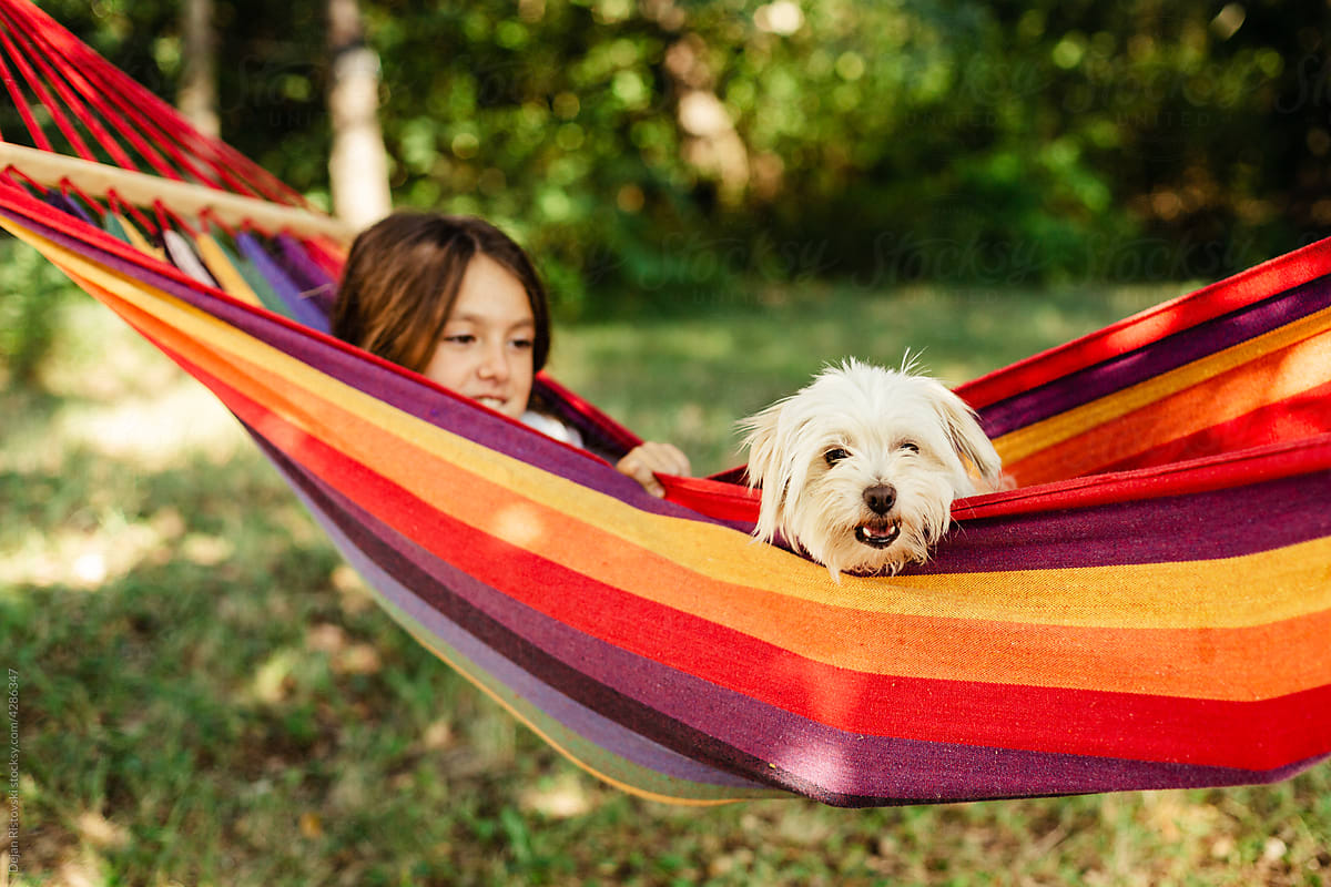 Girl and her dog in hammock