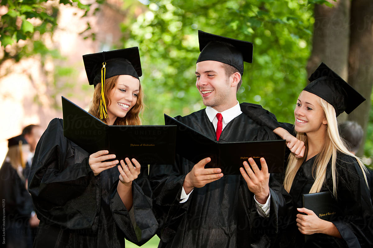 Graduation: Three Friends Looking at Graduation Diplomas
