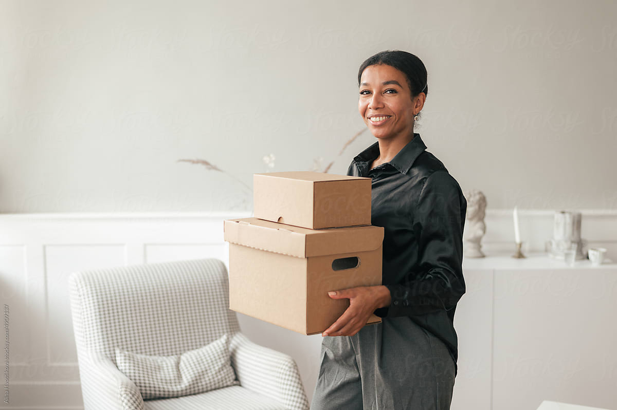 Smiling black woman with carton boxes