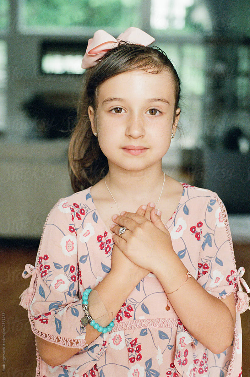 Portrait Of A Beautiful Young Girl With Her Hands On Her Chest Del Colaborador De Stocksy 
