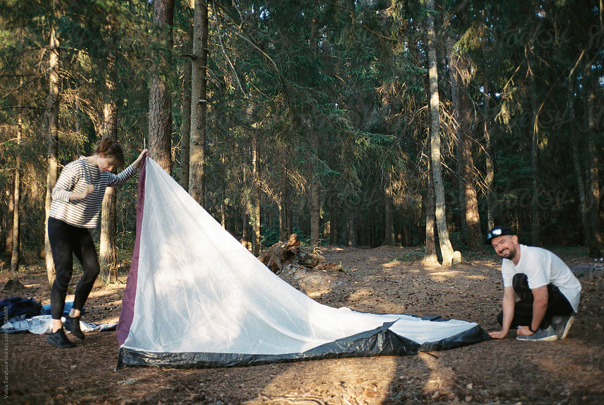 Young friends try to set up a tent
