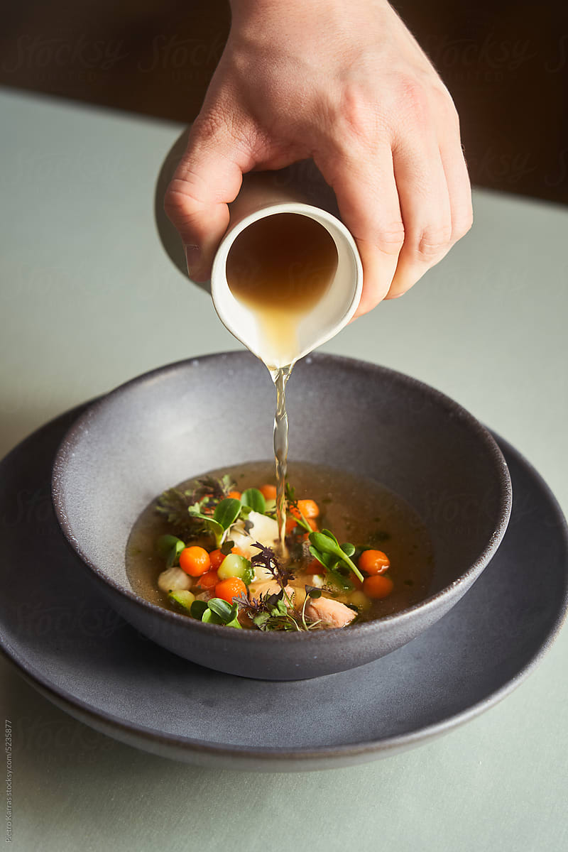 Chef pouring soup in fine dining restaurant