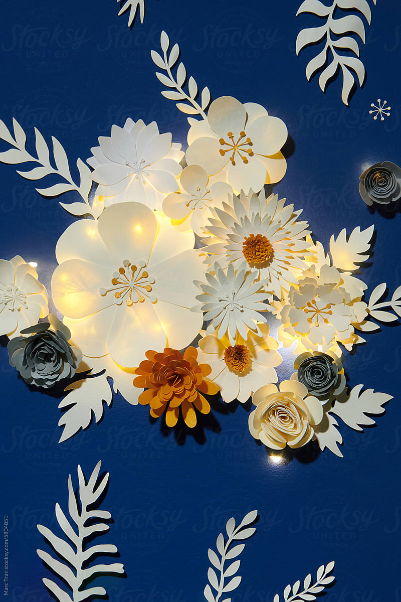 Beautiful handmade paper flowers on blue background
