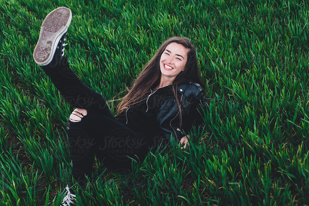 Cool young woman smiling on the grass