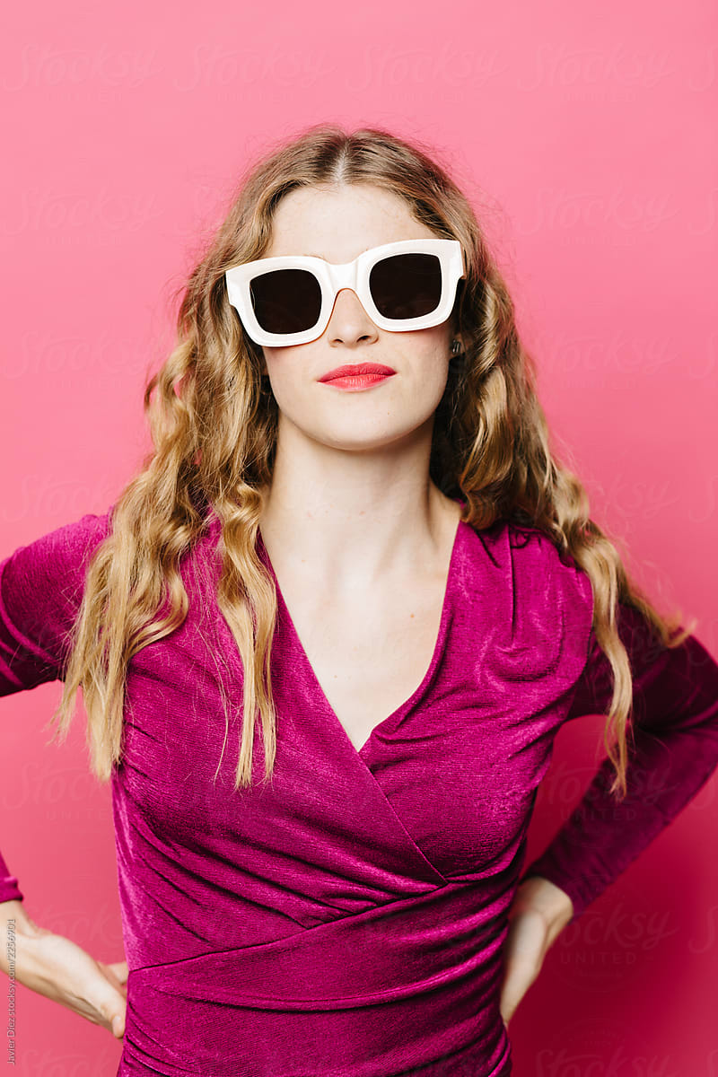 Modern young woman in dress and sunglasses