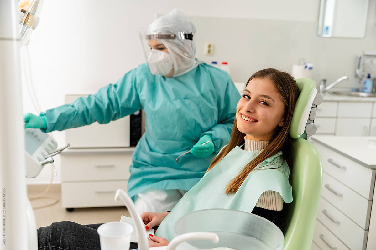 Smiling patient sitting on dental chair