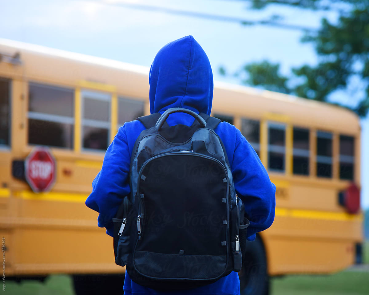 Boy Student Waiting in Front of School Bus Outside