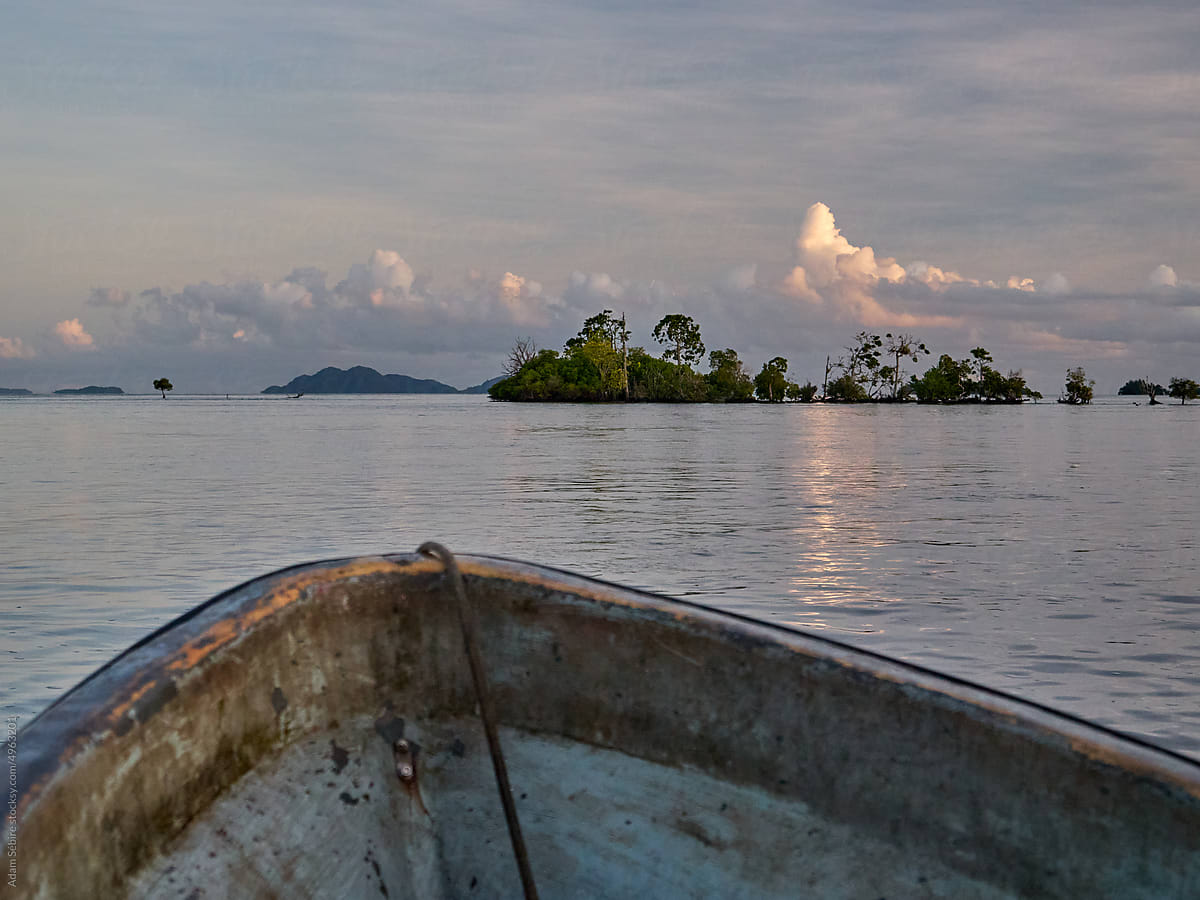Boat in low-lying mangrove islands in Pacific lagoon rising sea levels