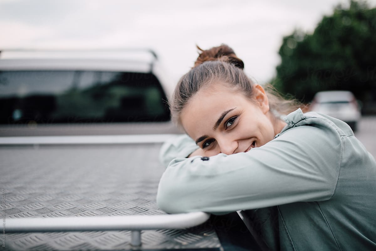 Young Woman Leaned On A Car