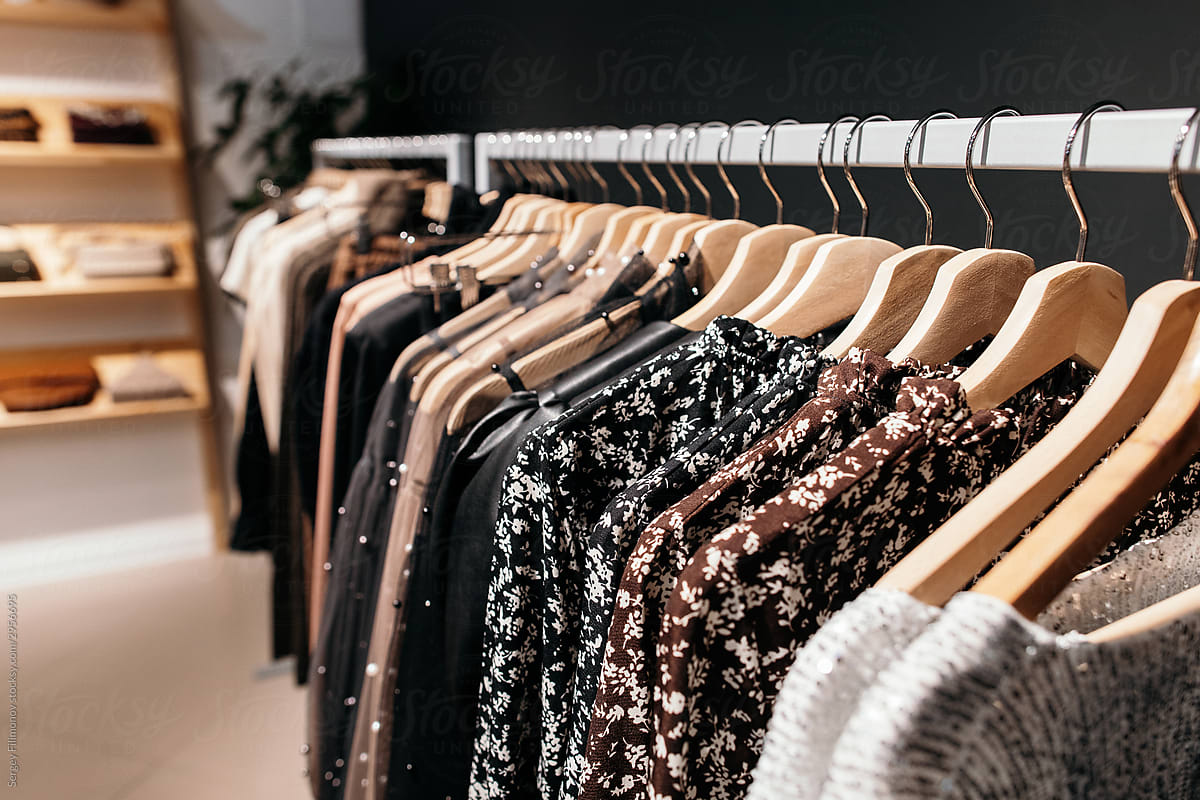 Rack with trendy clothes in store
