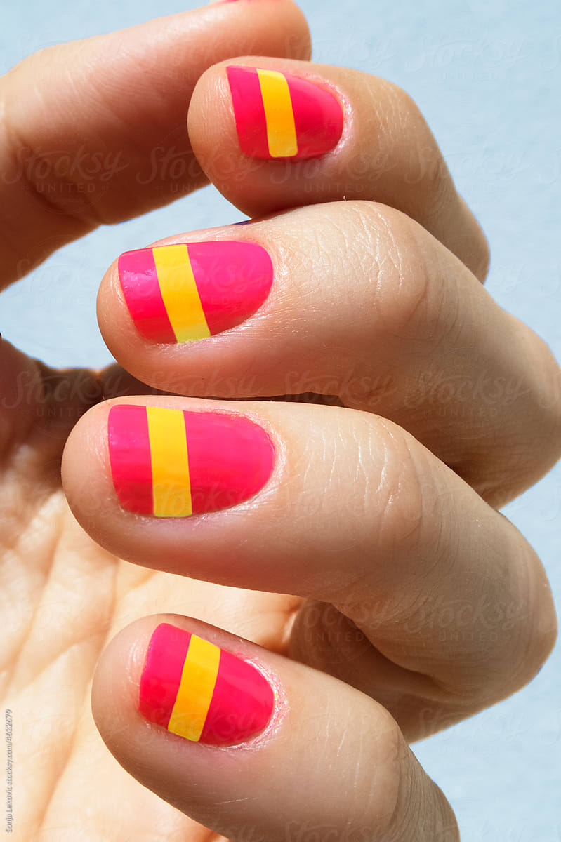 pink and yellow nails closeup