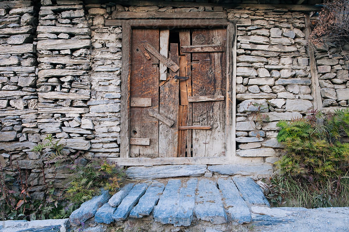 A door made with many planks and pieces of wood.