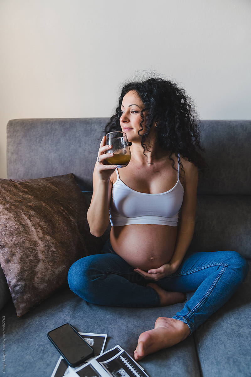 Pregnant Woman at Home Drinking Fruit Juice