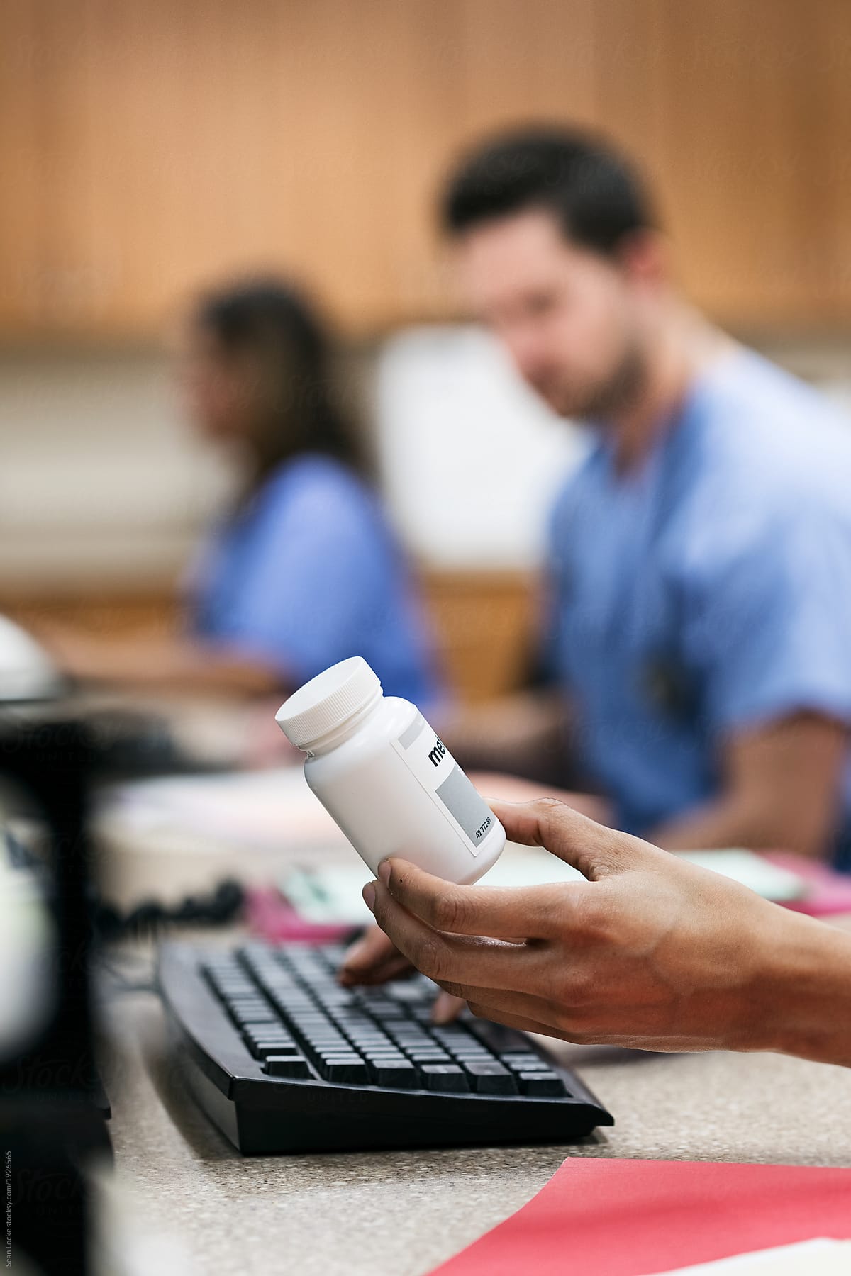 Clinic: Anonymous Tech Holding Pill Bottle