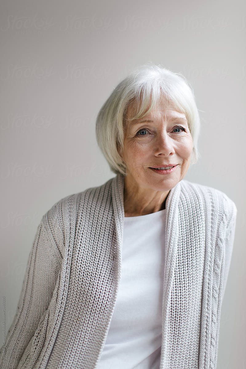 Studio portrait of senior woman on simple grey background
