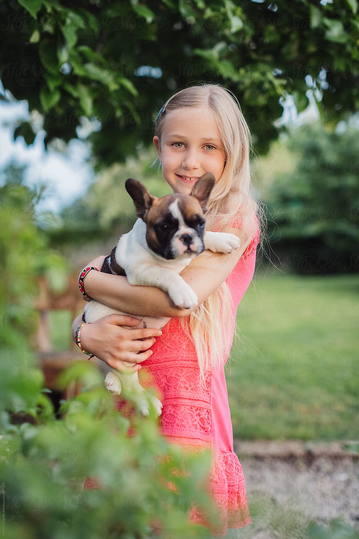 Young girl embracing her dog