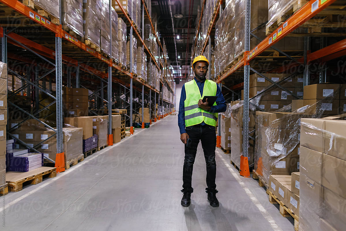Warehouse pallete boxes aisle. Employee storage managment